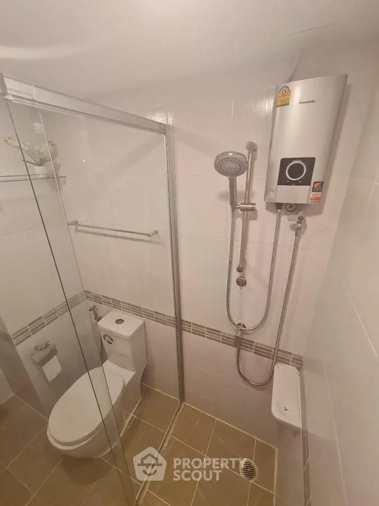 Modern bathroom with glass shower enclosure and water heater