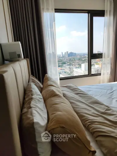 Luxurious bedroom with stunning city view from large window, featuring elegant bedding and modern decor.