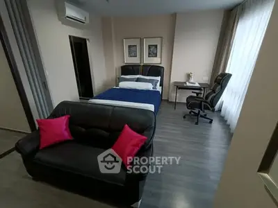 Modern bedroom with sleek furniture and stylish decor, featuring a cozy bed and work desk.