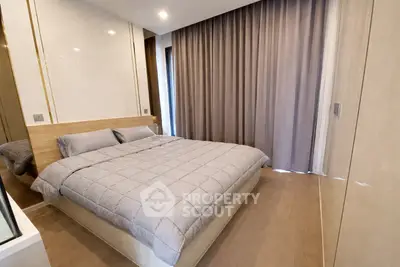 Modern bedroom with cozy bed and elegant curtains in a stylish apartment