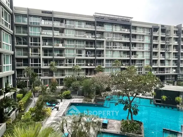 Luxurious condominium with pool view and lush greenery