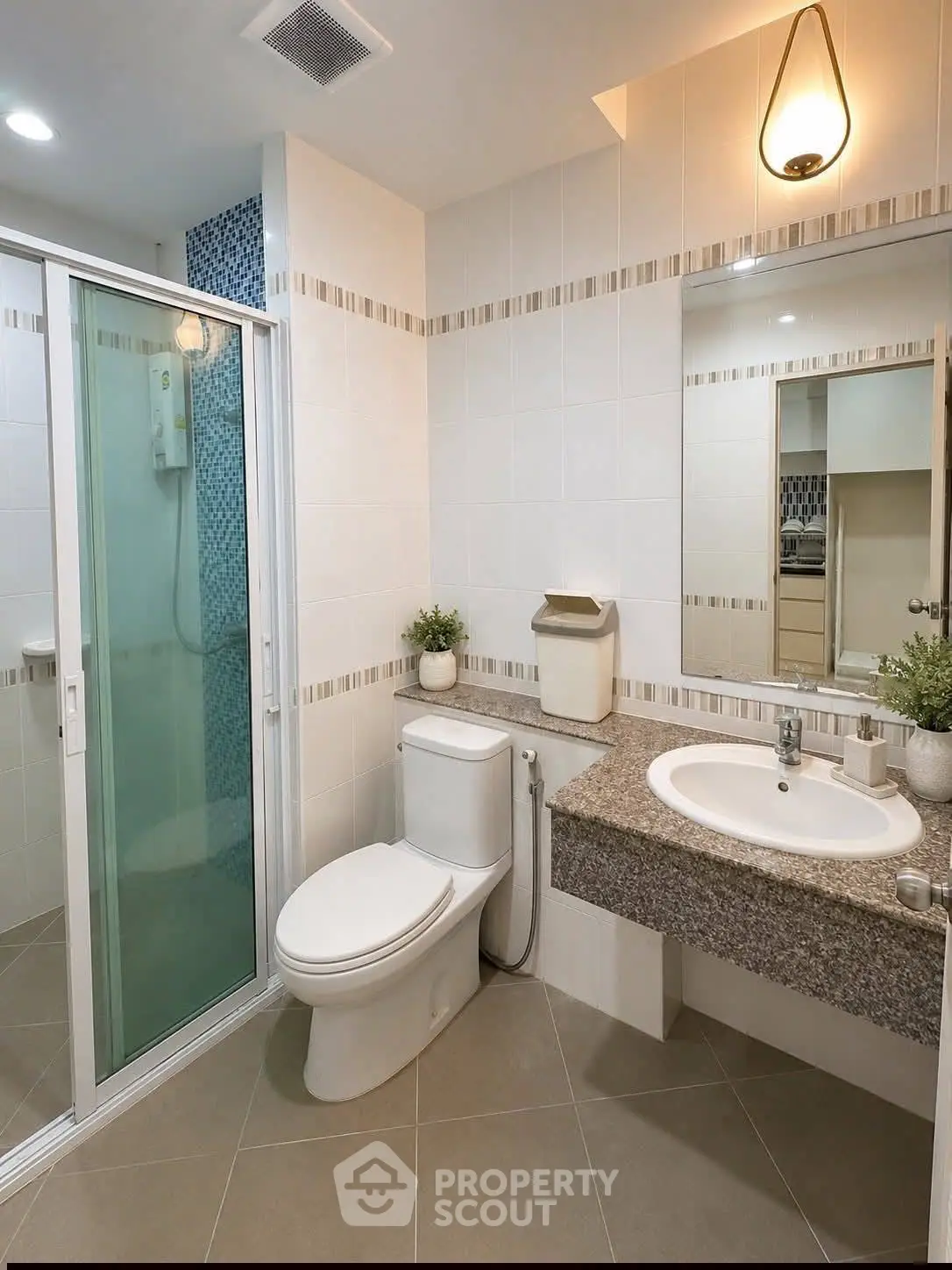 Modern bathroom with sleek shower, elegant sink, and stylish lighting in a contemporary home.