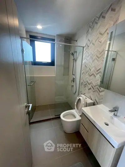 Modern bathroom with glass shower and sleek fixtures