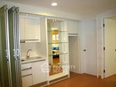 Modern compact kitchen with sleek cabinetry and open shelving