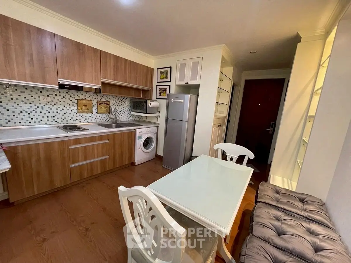 Charming kitchen with modern appliances and cozy dining area, perfect for urban living.