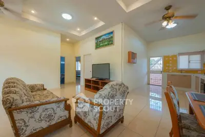 Spacious living room with elegant furniture and open kitchen layout in a modern home.
