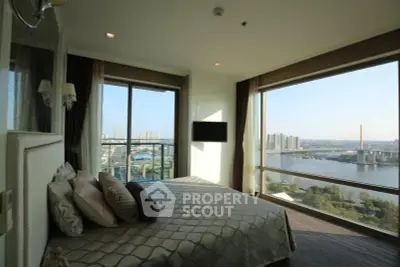 Luxurious bedroom with panoramic city and river views, featuring elegant decor and floor-to-ceiling windows.