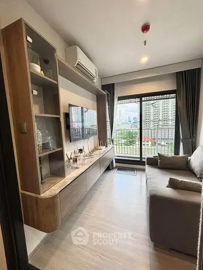 Modern living room with city view, featuring sleek furniture and large windows for natural light.