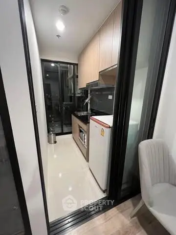 Modern compact kitchen with sleek cabinetry and appliances