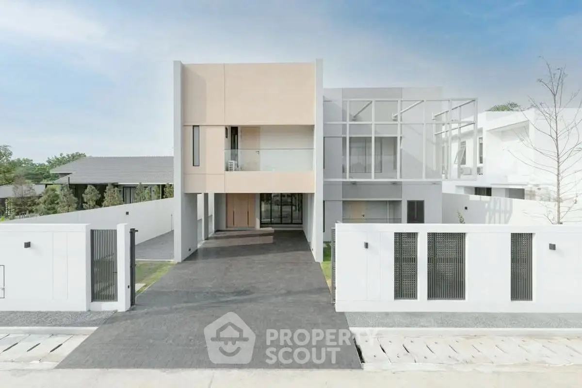 Modern minimalist two-story house with sleek facade and spacious driveway
