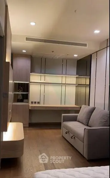 Modern bedroom with stylish furniture and wooden flooring