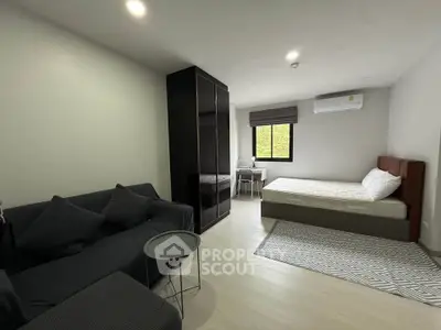 Modern studio apartment with sleek furniture and natural light