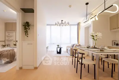 Modern open-plan living and dining area with stylish lighting and natural light.