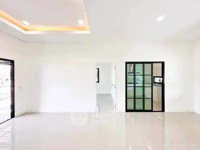 Spacious modern living room with sleek tile flooring and recessed lighting.