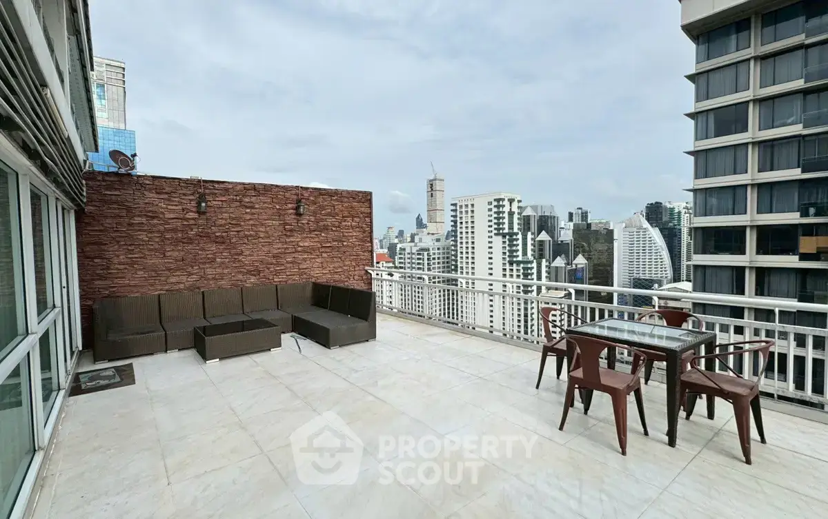 Spacious rooftop terrace with stunning city skyline views and modern outdoor seating.