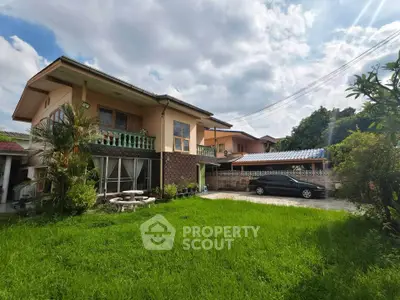 Charming two-story house with lush green lawn and spacious driveway in a serene neighborhood.