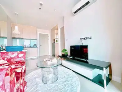 Modern living room with stylish decor and open kitchen layout in a contemporary apartment.