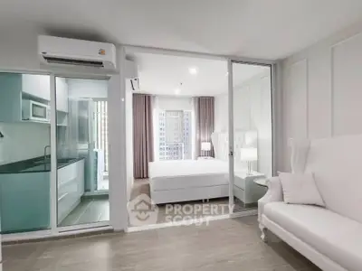 Modern apartment interior with open layout, featuring a stylish kitchen and cozy bedroom with elegant decor.