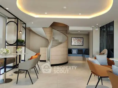 Luxurious modern living room with elegant spiral staircase and stylish seating area.
