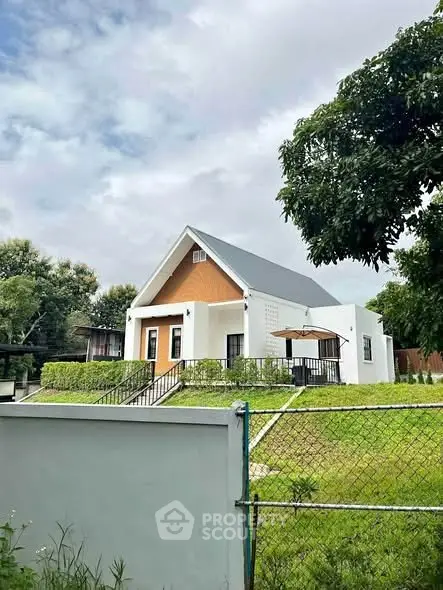 Charming modern house with lush green lawn and sleek architecture, perfect for serene living.