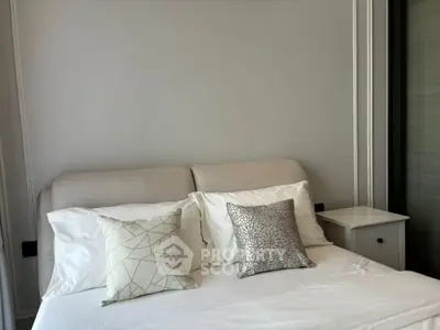 Modern bedroom with stylish decor and cozy bedding in a contemporary apartment.