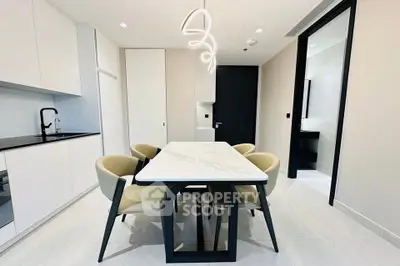 Modern dining area with sleek table and chairs in a contemporary kitchen setting.
