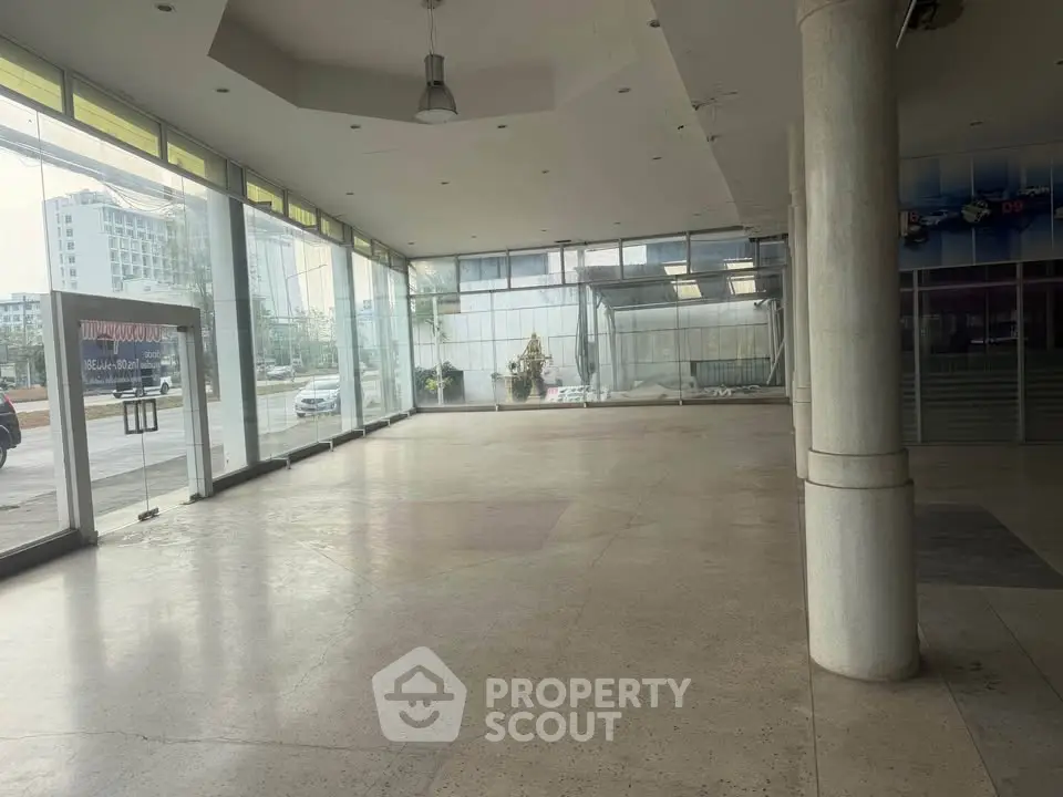 Spacious commercial property with large windows and open floor plan, ideal for retail or office space.