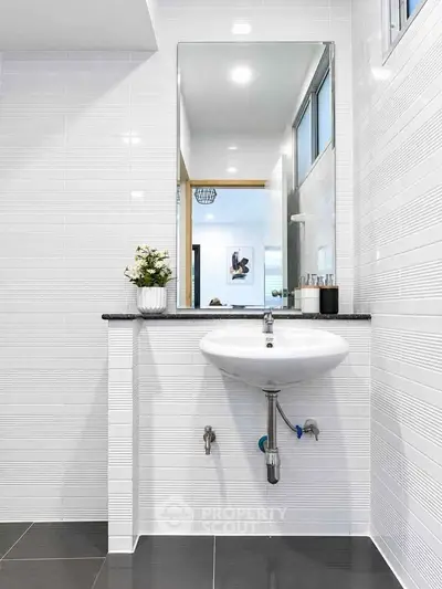 Modern bathroom with sleek white tiles and stylish sink design