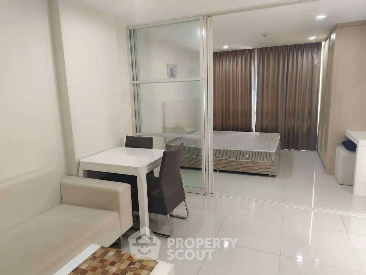Modern studio apartment with open layout and elegant furnishings.