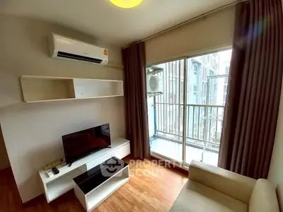 Modern living room with balcony view, featuring air conditioning and sleek furniture.