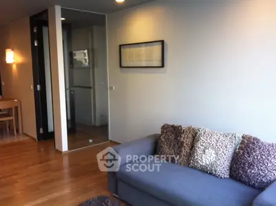 Modern living room with cozy sofa and stylish decor in a contemporary apartment.