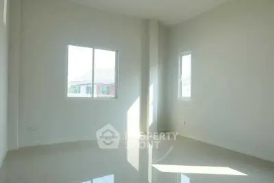 Bright empty room with large windows and glossy floor tiles