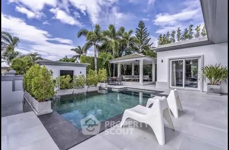 Luxurious modern villa with private pool and lush greenery, perfect for relaxation and entertainment.