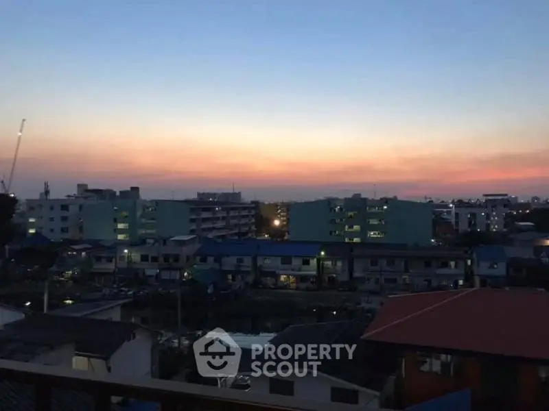 Stunning sunset view over urban skyline with residential buildings.