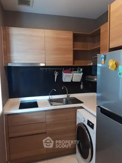 Modern kitchen with wooden cabinets, sleek appliances, and efficient layout