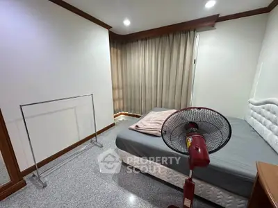 Cozy bedroom with modern decor and natural light, featuring a comfortable bed and stylish furnishings.