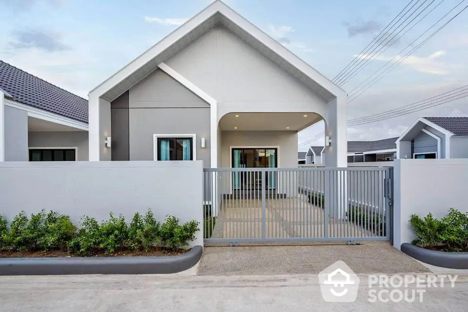 Modern single-story house with gated entrance and minimalist design