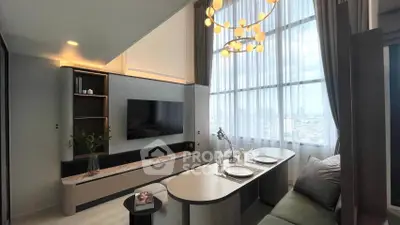 Modern living room with high ceilings and city view, featuring elegant lighting and stylish decor.