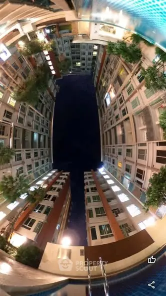 Stunning night view of modern apartment complex with pool