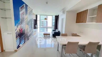 Modern living room with vibrant wall art and sleek furniture in a bright apartment.