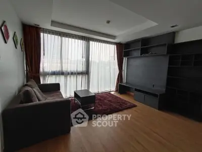 Spacious living room with large windows and modern furnishings