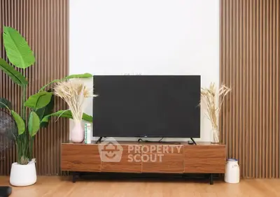 Modern living room with sleek TV stand and decorative plants