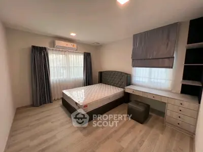 Spacious bedroom with modern decor and ample natural light