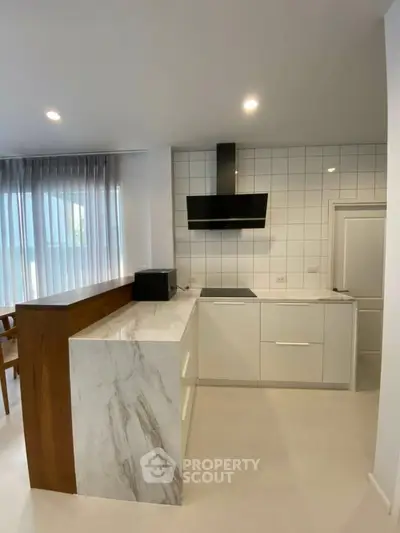 Modern kitchen with sleek marble countertop and open layout design