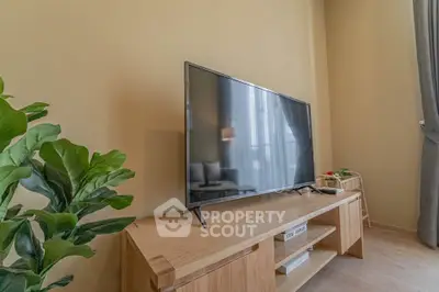Modern living room with sleek TV and stylish wooden furniture