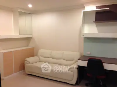Modern living room with sleek white sofa and built-in desk