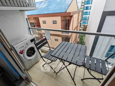 Charming balcony with washer and seating area in urban apartment