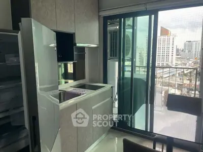 Modern kitchen with sleek appliances and city view from balcony