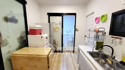 Charming kitchen with modern appliances and sliding glass doors leading to a cozy bathroom.