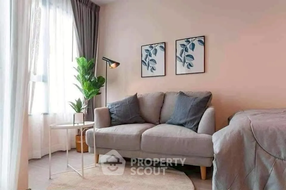 Cozy living room with stylish sofa and natural light, perfect for relaxation.
